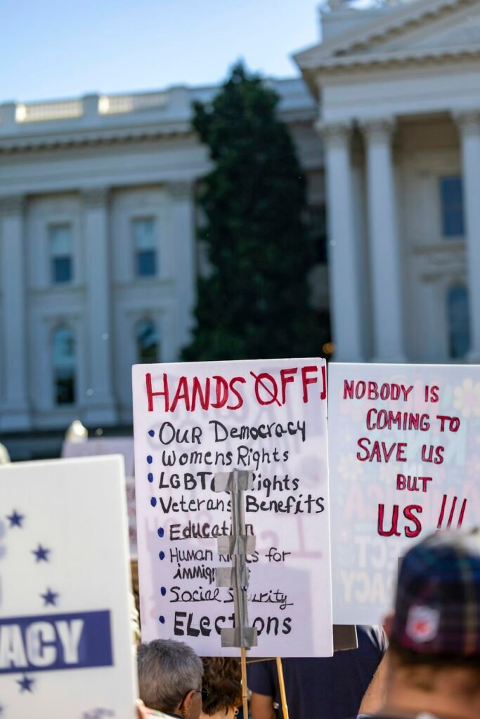 Protesters holding signs outside a government building